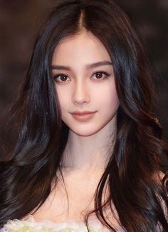 Woman with long dark hair looking directly at the viewer