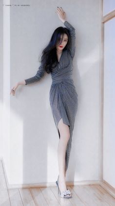 Woman in a sparkly dress and high heels posing indoors