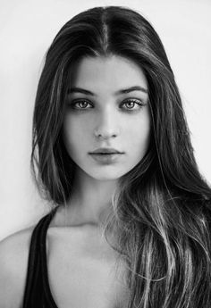 Black and white portrait of a young woman with long hair and a nose ring