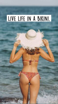 Woman in a bikini and straw hat from behind at the beach