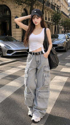Woman in cargo pants and a white tank top on a city street