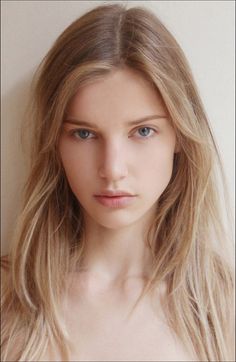Young woman with long blonde hair and blue eyes, looking directly at the viewer
