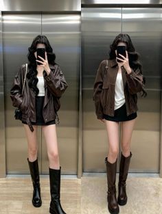 Woman in a leather jacket and mini skirt taking a mirror selfie