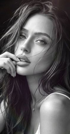 Black and white portrait of a woman with long hair in a provocative pose