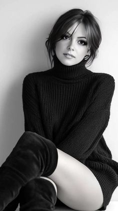 Woman in a black turtleneck sweater and thigh high boots in black and white