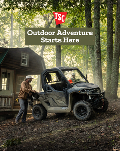 Man with an off-road vehicle next to a cabin in a forest