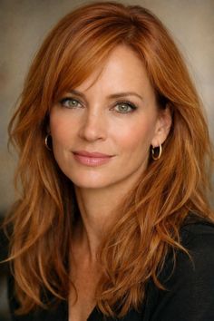 Woman with red hair and green eyes wearing hoop earrings