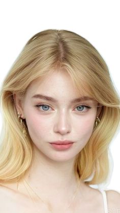 Young woman with blonde hair and blue eyes looking directly at the viewer