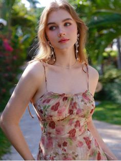 Woman in a floral dress with long blonde hair outdoors
