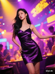 Woman in a purple satin dress posing in a nightclub with neon lighting