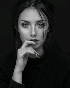 Woman in a black sweater with dark nails, in a black and white portrait
