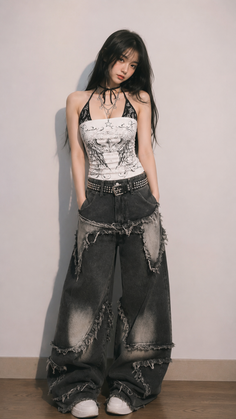 Woman with long dark hair wearing a halter top and baggy jeans indoors