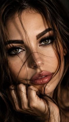 Close up portrait of a woman with dark hair and dramatic lighting