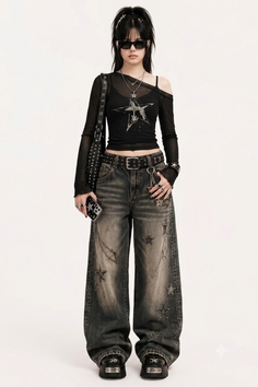 Woman in a black long sleeve top and baggy jeans with star details