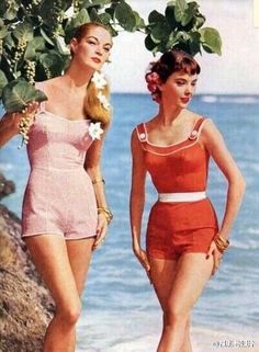 Two women in vintage swimsuits posing on a beach