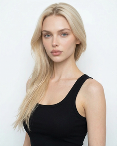 Woman with long blonde hair and blue eyes wearing a black tank top