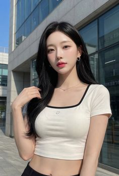 Woman with long black hair wearing a white crop top outdoors