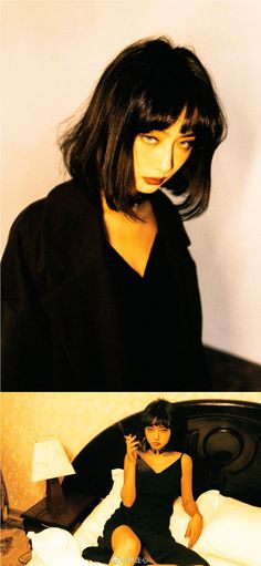 Woman with short black hair in a black dress, smoking in a bedroom