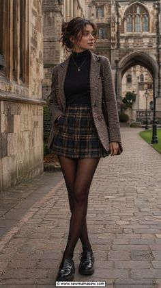 Woman in a plaid skirt and blazer walking on a cobblestone path