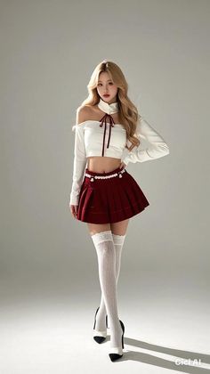 Woman with blonde hair in a crop top and pleated skirt with thigh-high socks