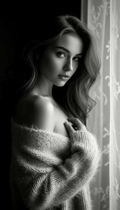 Woman with long hair in a knitted sweater, looking over her shoulder