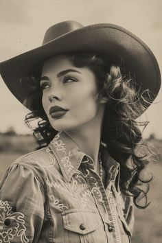 Woman in a cowboy hat and western shirt looking up, in sepia tone