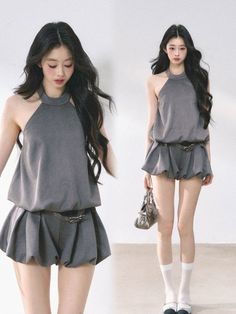 Woman with long black hair wearing a gray halter top and bubble shorts