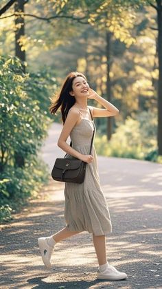 Woman in a light dress walking outdoors during golden hour