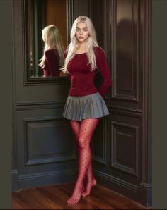 Woman with long blonde hair in a pleated skirt and red polka dot tights