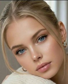 Close up portrait of a woman with blonde hair and blue eyes