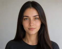 Woman with long dark hair and green eyes looking directly at the camera