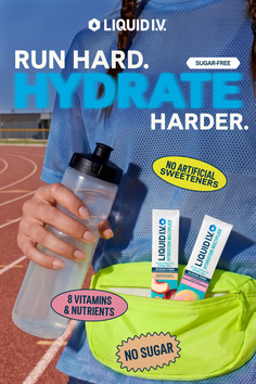 Person in athletic wear holding a water bottle and fanny pack on a running track