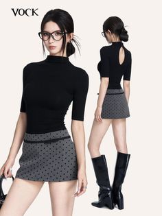 Woman in a black turtleneck and polka dot skirt with glasses and an updo