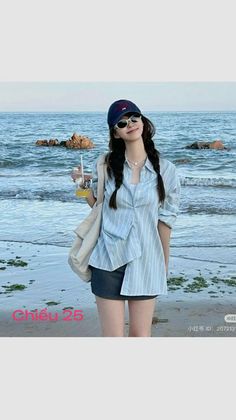 Woman with braids wearing a striped shirt and mini skirt on a beach