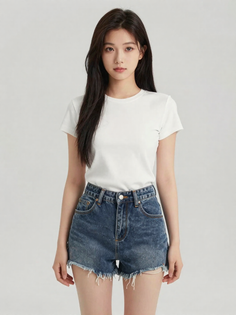 Woman with long dark hair wearing a white t-shirt and denim shorts