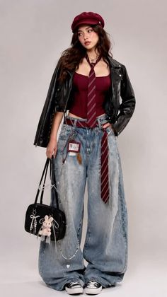 Woman in a leather jacket, red top, and wide leg jeans with a red tie