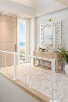 Coastal style entryway with an ocean view and light wood accents