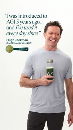 Man in a grey t-shirt and black shorts holding a green drink bottle