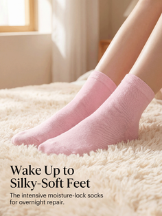Legs wearing pink socks on a fluffy rug indoors with soft lighting