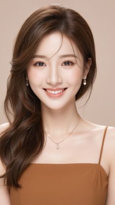 Woman with long brown hair wearing a brown top and jewelry, smiling at the camera