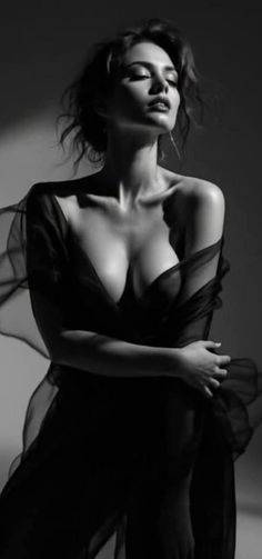 Woman in sheer fabric with dramatic lighting in black and white