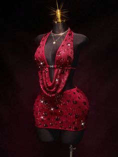 Red sequined dress on a mannequin with a dark background