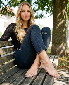 Woman with long blonde hair sitting on a wooden bench outdoors