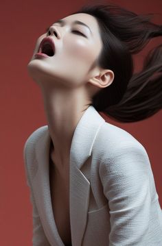 Woman in a white blazer with an open mouth and head tilted back