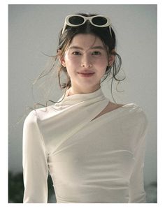 Woman with sunglasses on her head wearing a white top