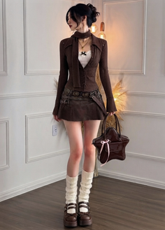 Woman in a brown cardigan and mini skirt with leg warmers and a star shaped bag
