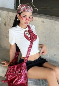 Woman in a crop top and mini skirt with a red bandana and glasses
