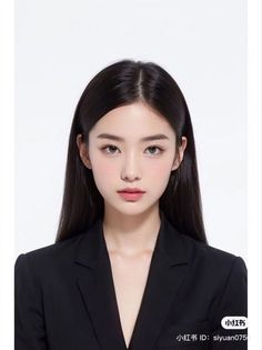 Woman with long black hair wearing a black suit against a white background