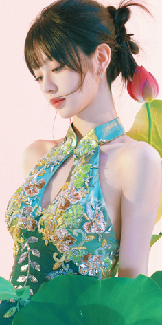 Woman in an embroidered halter dress with a lotus flower and leaves