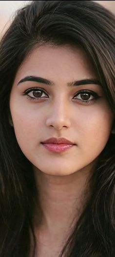 Close up portrait of a woman with long dark hair and glossy lips